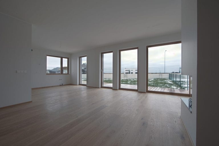 empty bright room with three windows and tiles